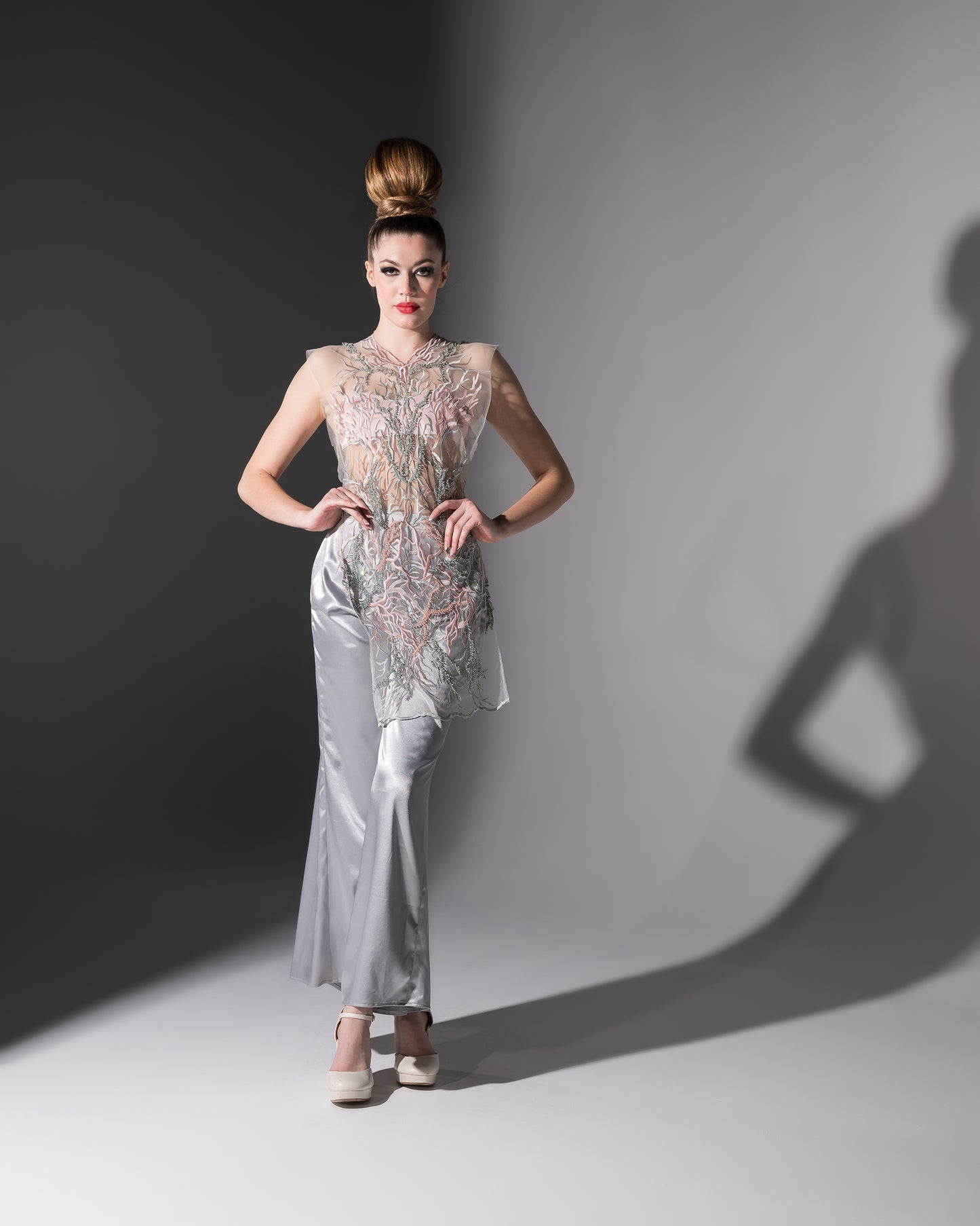 Woman in a stylish outfit with a gray background